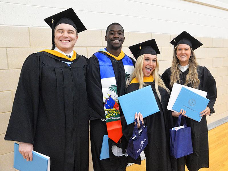 Immaculata University commencement - 4 students in caps and gowns